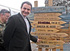José Luis Rodríguez Zapatero ante las señales indicadoras de las distancias a diversas ciudades españolas, de donde son naturales los soldados del contingente español, en esta ocasión de la Brigada de Cazadores de Montaña 'Aragón 1'.